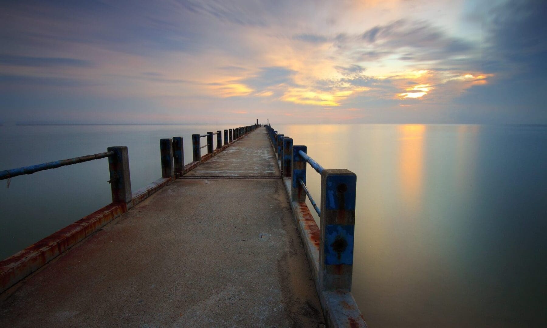 Sunset view from a pier over water.