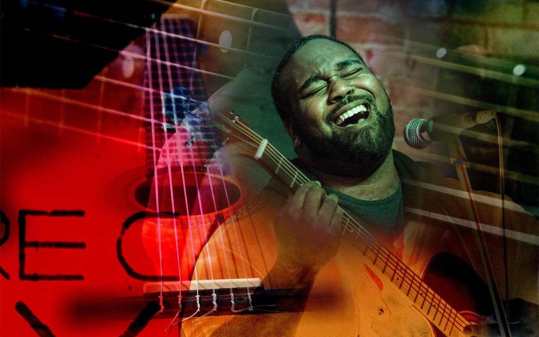 Singer passionately performing with guitar on stage.