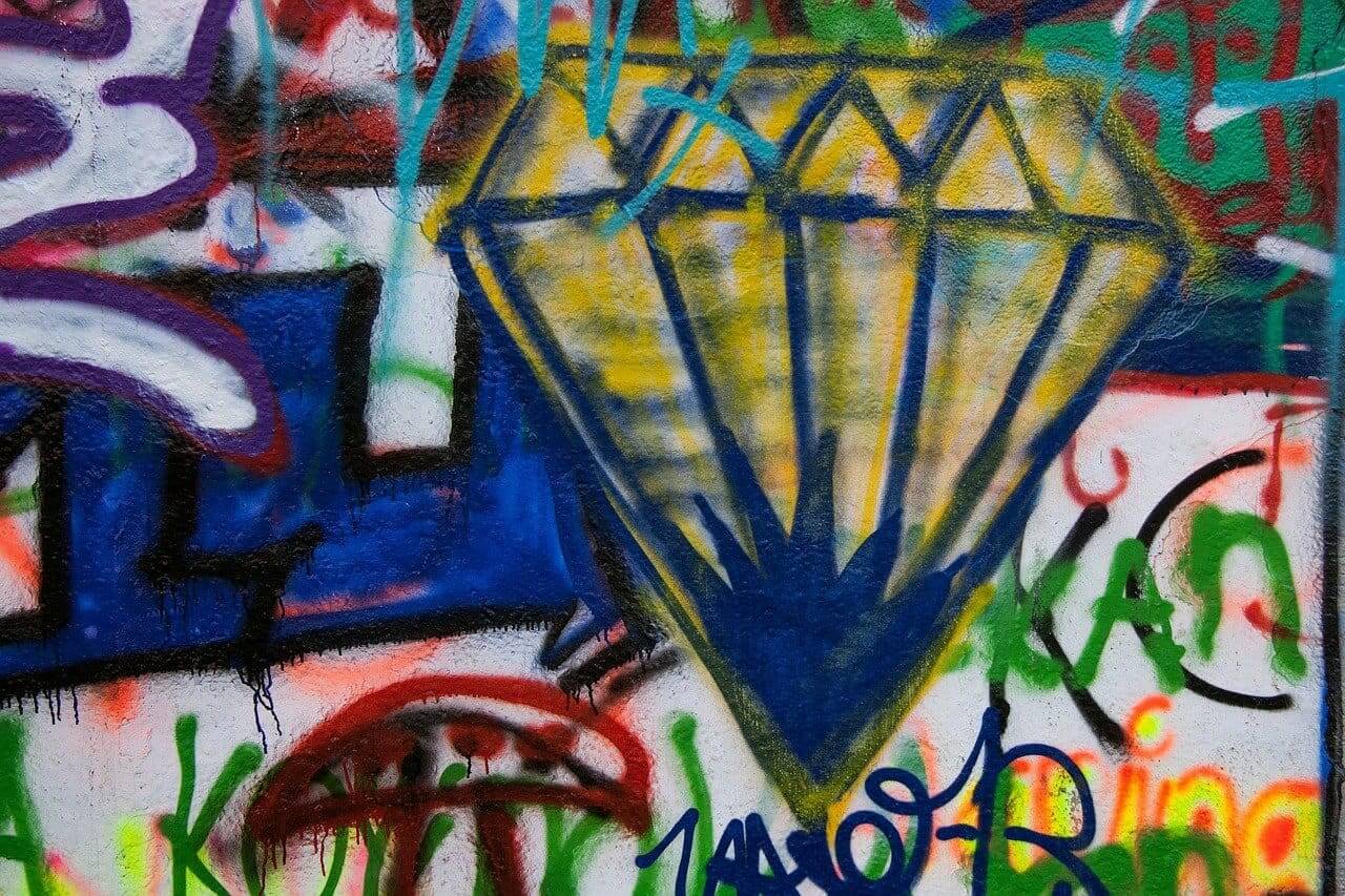 Graffiti wall with large painted diamond.
